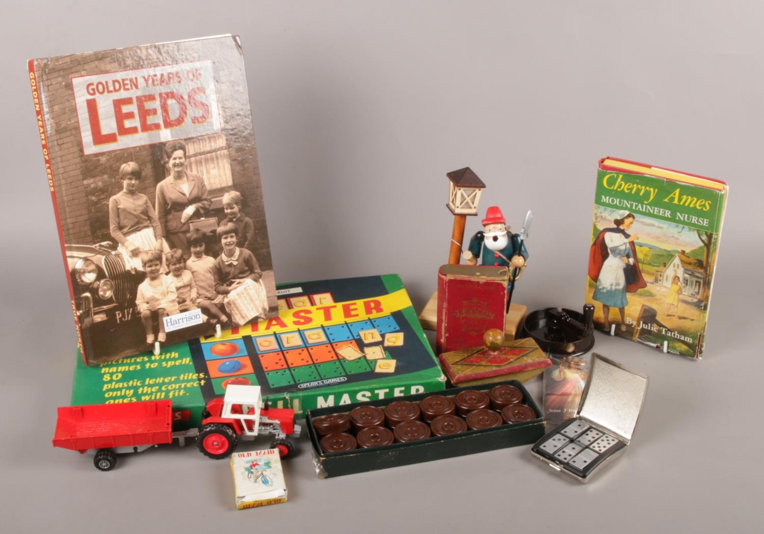 A collection of games and toys. To include Bakelite draughts, miniature metal dominoes and Spear's