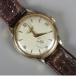 A gents 9ct gold Longines manual wristwatch on leather strap. Presentation inscription to back.