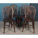 A set of four elm and beech Old Charm wheel back chairs. (90cm height 36cm width)