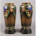 A pair of hand-painted Noritake vases with stands. H: 27cm.