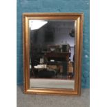 A gilt framed bevel edged mirror. (90cm height 65cm width)