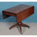 A Regency mahogany centre pedestal Pembroke table. Damage to drawer.