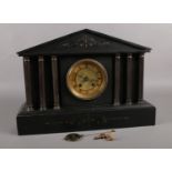 A polished black slate mantle clock by the Hamburg American Clock company. Has crossed arrow stamp