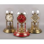 Three brass torsion clocks. Koma, Violeta. 33cm height.