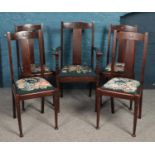 A set of five mahogany dining chairs with tapestry seat bases. One carver example.