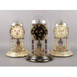 Three brass torsion clocks. Kundo. 29cm height