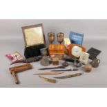 A box of collectable items. To include a series of letter openers, carved wooden alligator, a pair