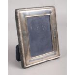 A small silver photo frame with beaded decoration. Assayed for Sheffield, 1996, by Carr's of