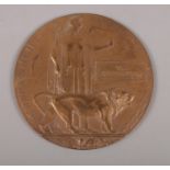 A bronze WW1 death plaque. Awarded 'Tom Hetherington' 12cm diameter.
