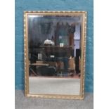 A gilt framed bevel edge mirror. (83cm height 57cm width)