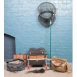 A large quantity of fishing equipment, including storage boxes, lures and nets.