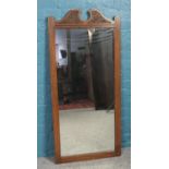 A carved oak Old Charm full length mirror.