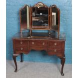 A mahogany dressing table. With triple mirror and raised on cabriole legs. (150cm x 106cm x 50cm)