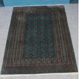 A teal ground bukara rug. With repeating diamond motif decoration. (187cm x 130cm)