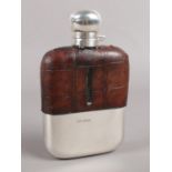 A silver and leather mounted hip flask. Assayed Sheffield 1905 by James Dixon & Sons Ltd.