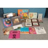 A box of vinyl records and pictures. To include records from Stevie Wonder (Limited edition 3 record