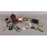 A box of assorted collectables. To include two Colibri lighters, a green glass ashtray, a boxed pair