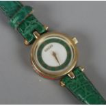 A boxed ladies Gucci wristwatch. With green and red enamelled decoration.