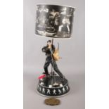 An Elvis Presley lamp along with an Elvis belt buckle.