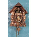 A German carved cuckoo wall clock. with Regula, West Germany movement and Swiss Musical movement,