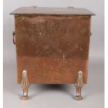 A large twin handled copper coal scuttle/log box, raised on club feet.