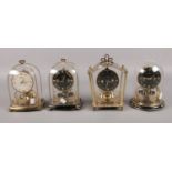 Four brass Schatz brass torsion clocks.