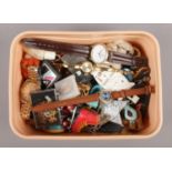 A tub of collectables. To include keyrings, badges and quart wristwatches.