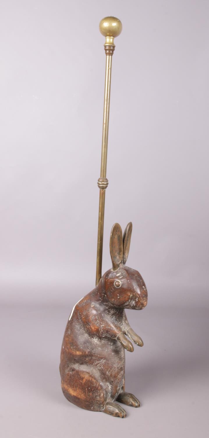 Two hardwood table lamps and an antique carved wooden rabbit and brass doorstop: H:63cm. Paint - Image 3 of 4