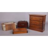 Four assorted wooden and animal skin boxes. To include a mahogany tea caddy with brass handle, a