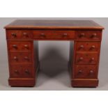 A Victorian mahogany twin pedestal desk with leather inset top.