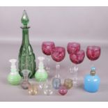 A collection of glassware. Includes green glass decanter, scent bottle, cranberry flash drinking