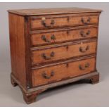 A George III oak chest of drawers with canted fluted corners. Height 79cm Width 85cm Depth 45cm.