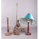 Two hardwood table lamps and an antique carved wooden rabbit and brass doorstop: H:63cm. Paint