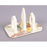 A Clarice Cliff Wilkinson three bar toast rack decorated in the Passion Fruit design. (13cm x 9cm)