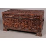 An extensively carved Chinese hardwood trunk with camphor wood lining. The feet formed as dog of fo.