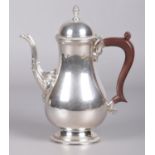 A silver hot water pot assayed Birmingham 1967 by Barker Ellis Silver Co. Having acorn finial,