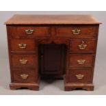 A George III walnut kneehole desk. Height 82cm, Width 101cm, Depth 50cm. Bleaching. Marks, knocks