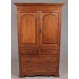 A Waring & Gillow carved oak linen press. With double panel doors over four drawers, raised on