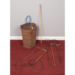 A wicker basket with riding crops, whips and a bamboo walking stick. To include a brass handled