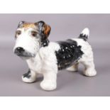 A Fieldings Crown Devon figure of a Terrier dog. Figure has glass eyes. H: 17cm, L: 27cm. Repair