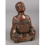 A bronzed figure of a seated Chinese man with bowl. H: 11.5cm W: 8cm. Missing piece to the