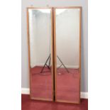 Two wooden framed bevelled edged wall mirrors. H: 133cm, W: 36cm.