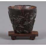 A miniature Chinese libation cup, possibly 18th century. Carved from a seed or nut and decorated