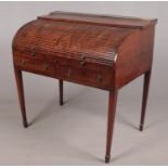 A George III / Regency mahogany tambour front writing desk with fitted interior. Metal supports to