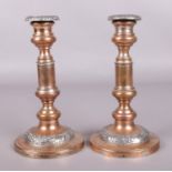 A pair of Copper candlesticks with detachable nozzles.