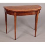 A George III mahogany bow fronted card table raised on square tapering supports. Banded in satinwood