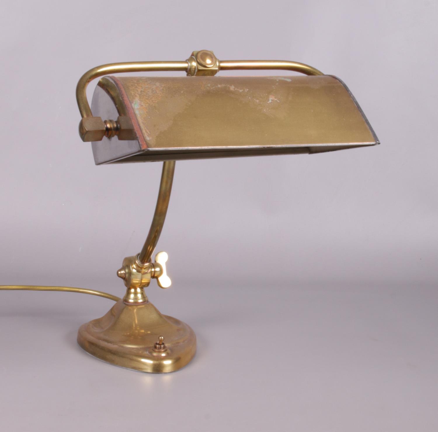 A vintage brass desk lamp.