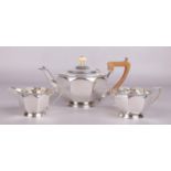 A George V silver three part tea set assayed Sheffield 1931 and 1934 by George Howson. The teapot