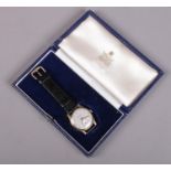 A gents 9ct gold Garrard manual wristwatch on leather strap. In original box. Running.