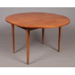 A circular teak drop leaf dining table. H: 74cm, D:115cm, W:125cm (fully open). Joints need some